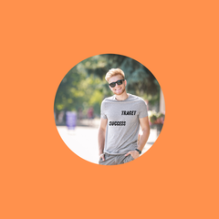 Man wearing a casual men’s t-shirt, smiling outdoors against an orange background